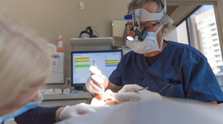 Dentist performing oral surgery with precision at Dental Nation in Las Vegas, NV.